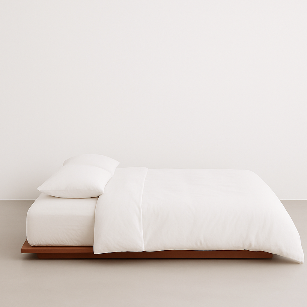 White Bamboo bedding set on a wooden bed frame against a white wall